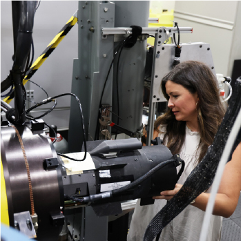 Image of a woman working on a machine in the AMSTAR lab